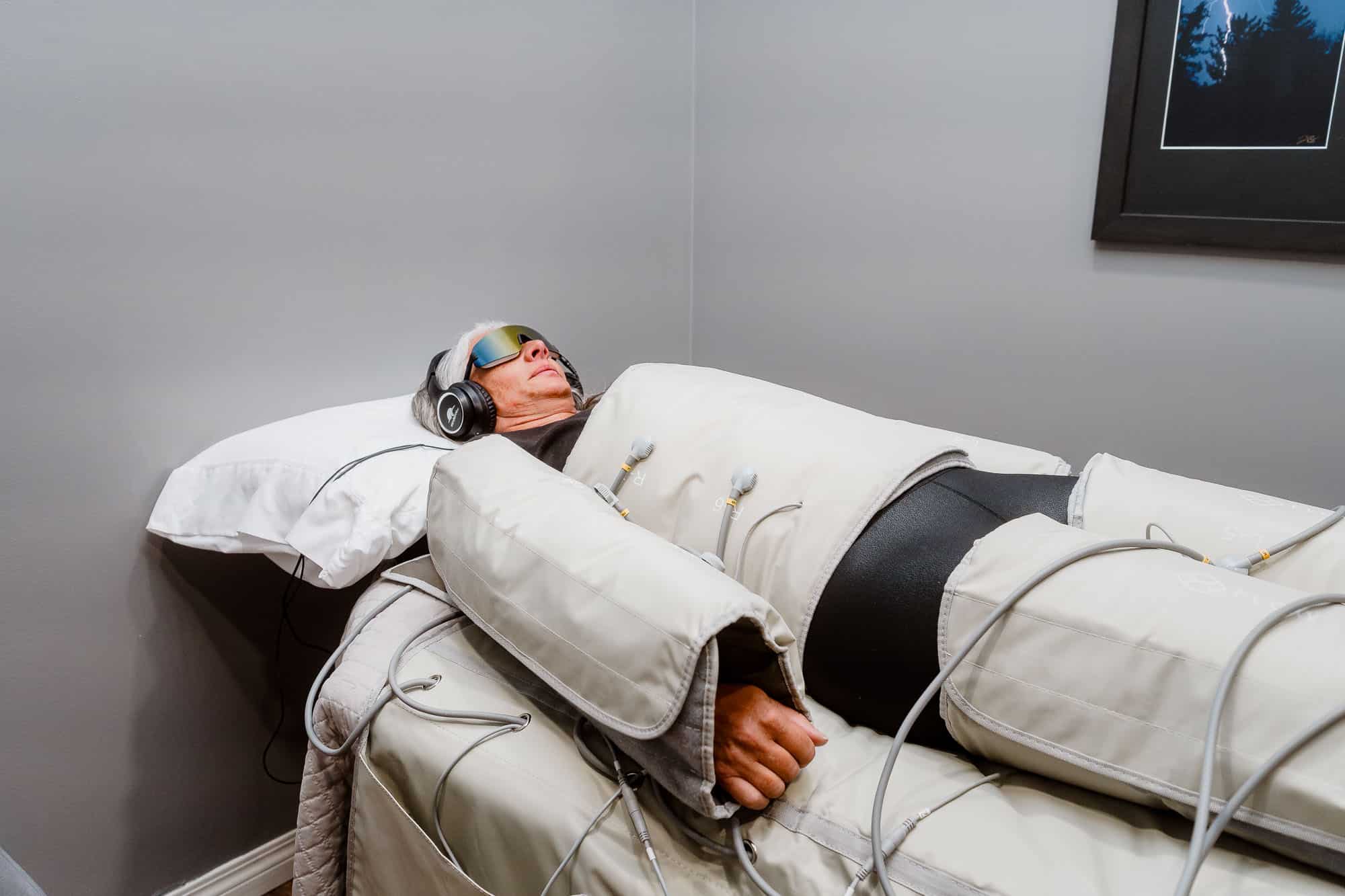 Customer receiving Lymphatic Drainage Therapy with compression machine
