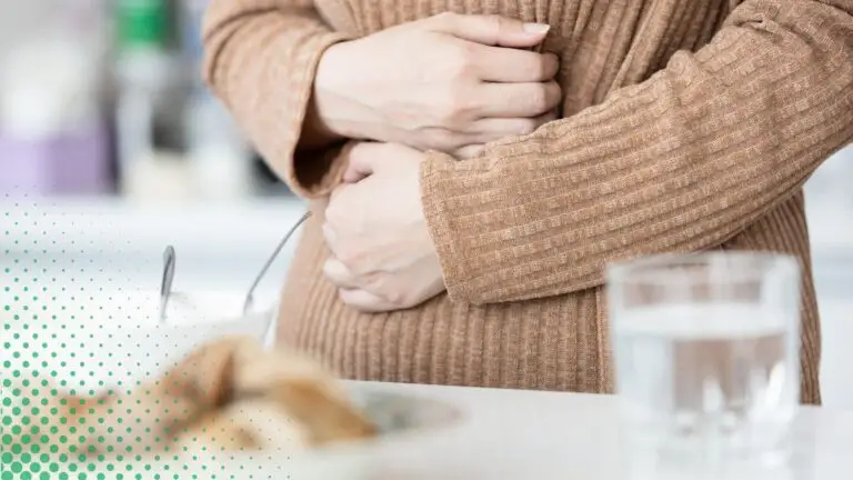 A woman holding her gut to emphasize IBD