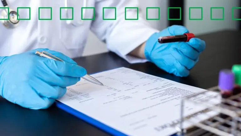 A doctor holding a vial of blood while looking at the results from a patients heavy metal testing.