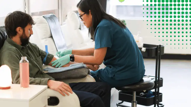 A patient receiving IV therapy from a nurse