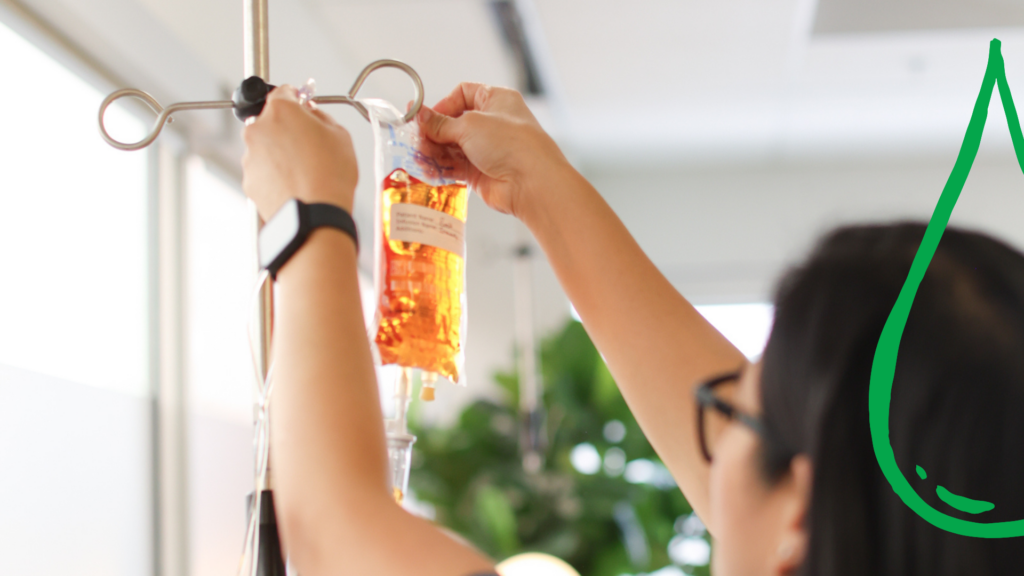 A nurse hanging an NAD IV bag in a clinic