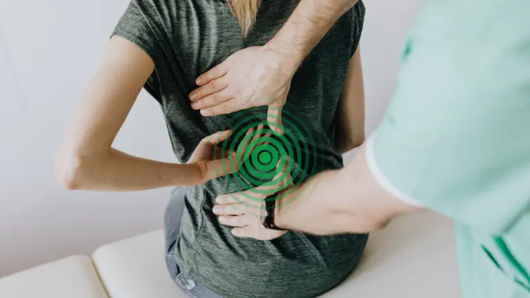 A naturopath assessing a patients back pain