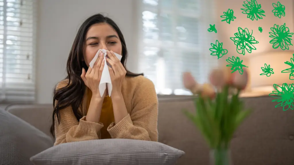 A woman suffering from allergies and blowing her nose