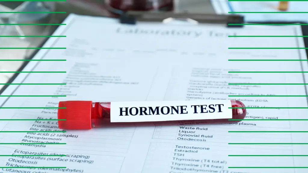 A vile of blood sitting on top of hormone testing results
