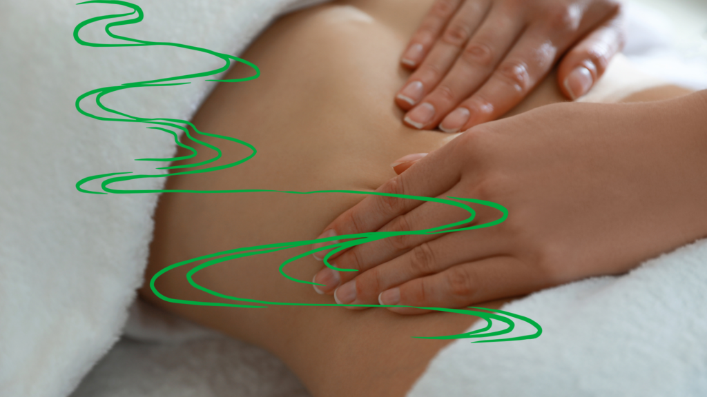 A masseuse providing a lymphatic drainage massage on a clients abdomen